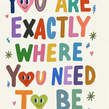 Colorful motivational quote "You are exactly where you need to be" with smiley faces on a white background